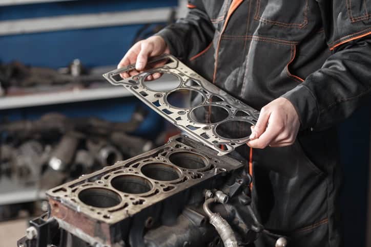 The mechanic disassemble block engine vehicle. Engine on a repair stand with piston and connecting rod of automotive technology. Interior of a car repair shop