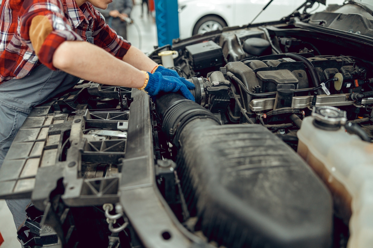 mechanic looking at engine