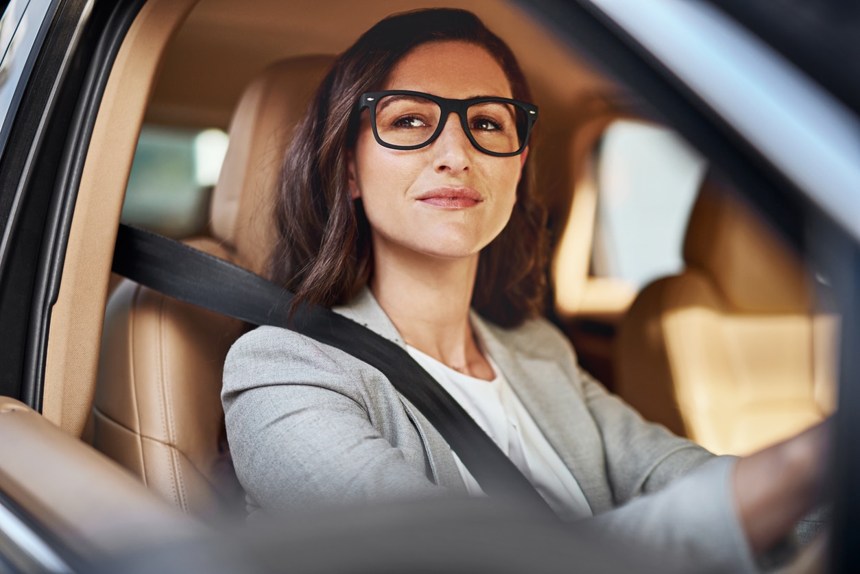 woman wearing glasses driving