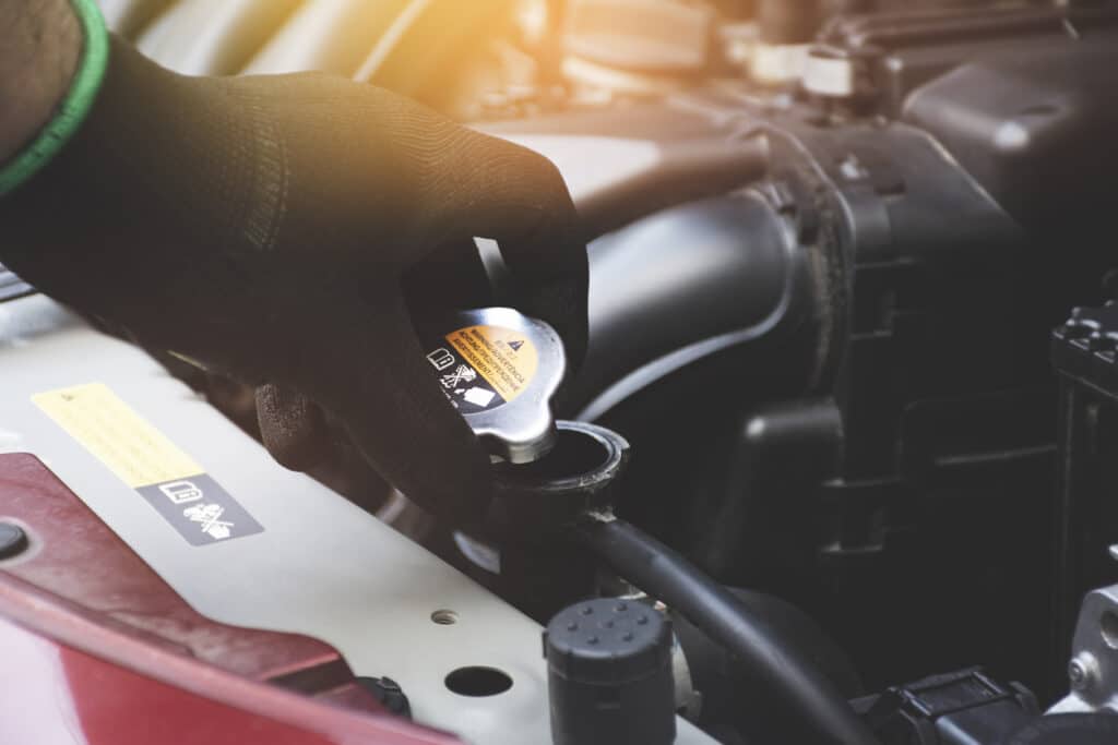 mechanic taking off radiator cap