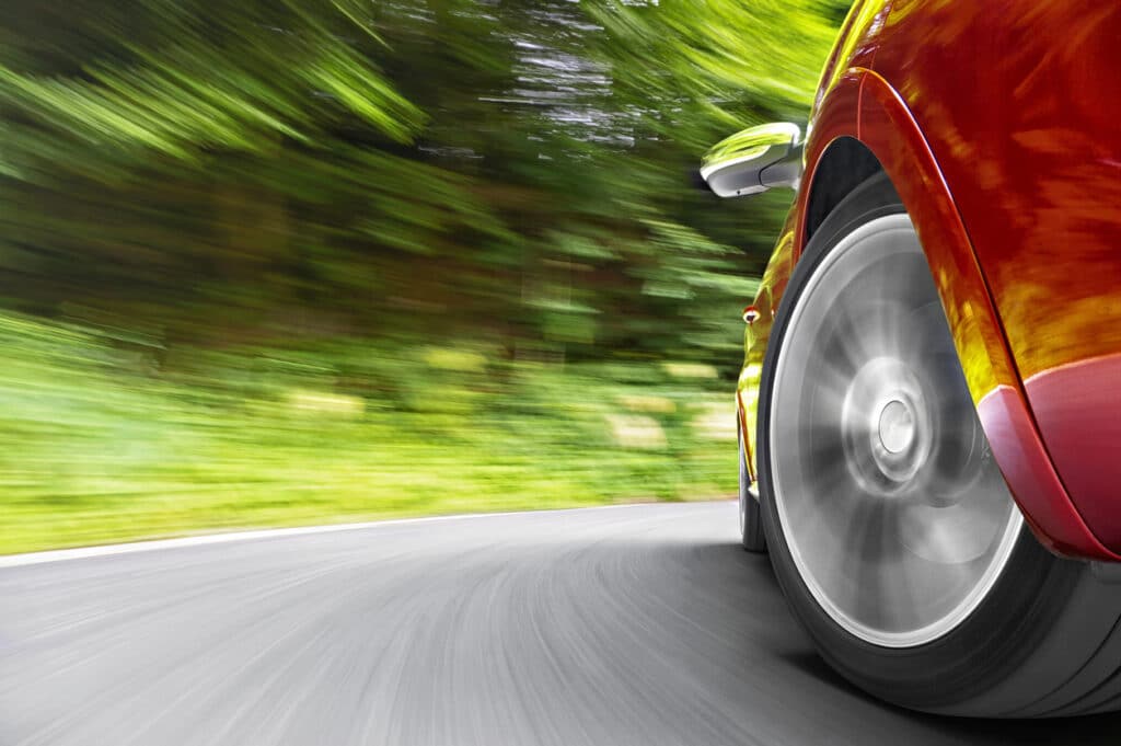 Close up shot of a car while driving in the curve