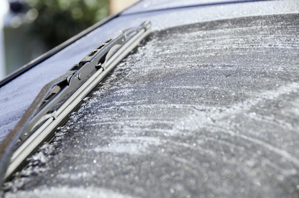 Windshield wiper frozen to car windshield